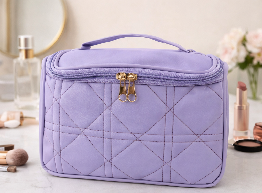 Lavender quilted beauty case on a vanity table with makeup items